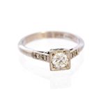 An Art Deco diamond solitaire ring, diamond set shoulders,