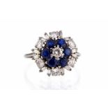 A diamond and sapphire three tier white gold cluster ring,