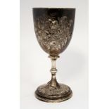 A mid Victorian silver chalice, London 1876, the bowl with embossed floral decoration,