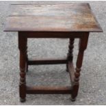 A late 17th Century oak joined side table, two plank top, standing on turned legs,