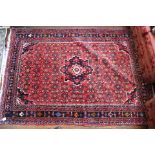 A Hamadan design carpet, blue and red ground,