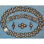 A silver and mother of pearl suit of jewellery, comprising necklace, bracelet and pendant earrings,