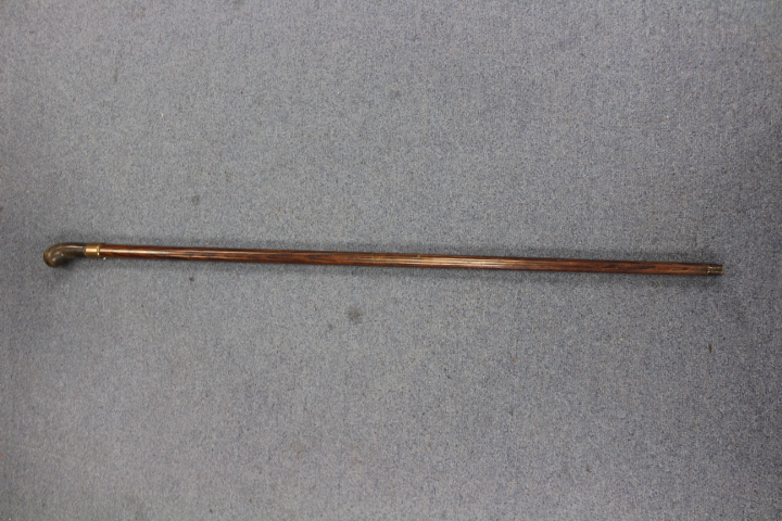 A late 19th/ early 20th Century rosewood walking cane, horn handle, brass ferrule,