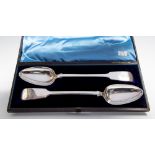 A pair of Victorian silver Fiddle pattern serving spoons, each handle engraved with initials,