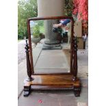 A Victorian mahogany dressing table mirror, the adjustable tilting mirror,