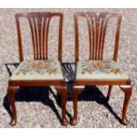 A pair of Irish early 19th Century mahogany chairs with cabriole legs with carved tassels to the