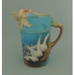 A Royal Worcester lion headed water jug, blue ground painted with swans, signed C. Baldwyn, No.