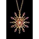 A Faberge diamond and ruby 14k yellow gold Sunburst pendant/brooch and chain,