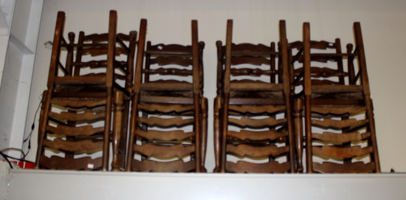 A set of eight oak ladder back chairs,