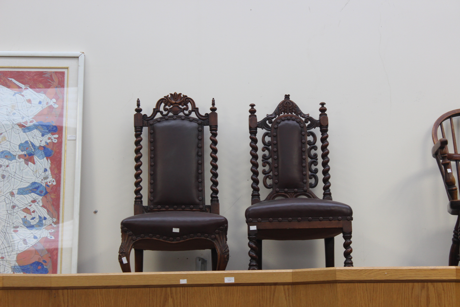Two mid Victorian Carolean style walnut high back chairs, having leather upholstered back panels,
