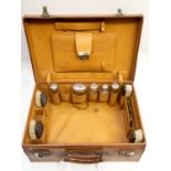 ***REOFFER IN NOVEMBER A&C £100/150***A gentleman's leather case containing silver topped faceted