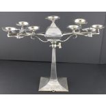 A Jewish interest white metal candelabra of unusual form, the central tapering column with tulip