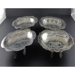 A set of eight Islamic white metal and niello dishes, of oval form having octofoil out swept pierced