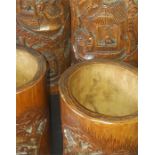 Four Chinese Qing dynasty carved bamboo brush pots, being two matching pairs, carved with figural