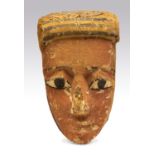 Egyptian Wooden Gesso Painted MaskLate Dynastic Period, 332 BC.A wooden mummy mask with red