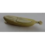 A Japanese carved ivory Okimono of partially peeled banana, late Meiji period, the skin stained