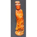 A 19th century Chinese stained and carved ivory figure of a lady with a young child at her feet,