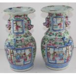 A pair of late 19th century Chinese famille rose vases, in typical palette, with applied chilong,