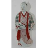 A 17th century Japanese porcelain figure, polychrome enameled in green and iron red, standing