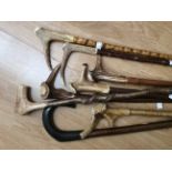 A collection of walking sticks with Antler handles and riding crop