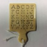 A rare late 18th/early 19th century ivory miniature alphabet hornbook, 4.5cm x 3cm.