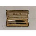 A Parker 51, black fountain pen and matching propelling pencil,