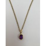 An amethyst pendant, the rub over set amethyst approx 8mm x 6mm, set in 18ct gold,