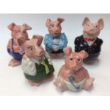 A collection of five Natwest Wade pig money banks