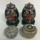 Two early Chinese pottery vases and covers, naively painted with stylised foliage,