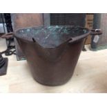A hand wrought copper mixing, cooking pan with twin handles and spoon,