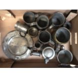 A collection of Pewter comprising of one plate and twelve Tankards.
