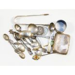 A quantity of silver spoons, cigarette case, sugar tongs, two Victorian silver coins,