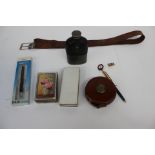 A treble, leather cased retractable tape measure, leather belt, hip flask, map/distance gauge,