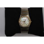 A Ladies' Omega "Constellation" gold and stainless steel, diamond set bracelet watch,