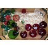 A collection of assorted decorative drinking glasses including claret glasses, coloured glassware,