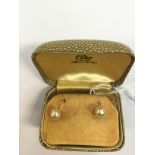 A pair of yellow metal and faux pearl screw earrings in Ciro earring box