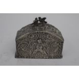 A silver casket with love bird finial foliate and cherub repose all over design,