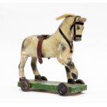 A George V child's pull-along toy horse, circa 1920's,painted gesso features on a wooden body,