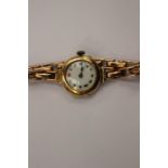 A Ladies 9 ct gold vintage bracelet watch on a 9 ct gold expanding bracelet