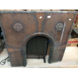 An Arts & Crafts copper fire surround insert,