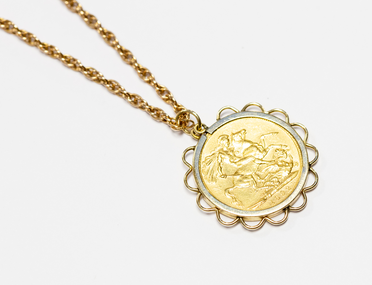 A Victorian gold Sovereign, dated 1892 in pendant mount suspended on 9ct chain,