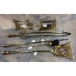 A collection of fireside brass, comprising of fire dogs, a coal scoop, a pair of coal tongs,