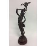 A reproduced figurine with bronze effect finish over a heavy metal body. Signed L Gregoire.