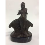 A Bronze letter rack with female standing figure. On a marble base. 24cm in height.