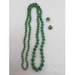 A graduated Jadenite bead necklace with 9 k clasp, together with a pair of Jadenite earrings,