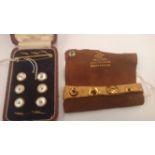A 1920s/30s 18ct marked set of four gents shirt studs in suede wallet and a set of six mother of