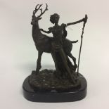 A Bronze figure of Diana and a Stag. On a marble base. 26cm in height.