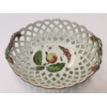 A Derby pierced oval basket, (rope handles) decorated with an apple and leaves with moths etc,