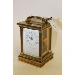 A Matthew Norman brass case and carriage clock, swing handle white enamel face,