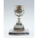 A late Victorian silver squat candlestick, London 1885, in the manner of Robert Adam,